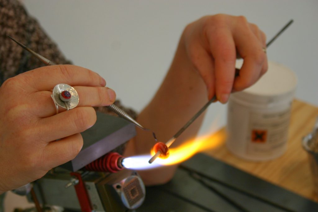 travail d'une perle de verre dans la flamme d'un chalumeau